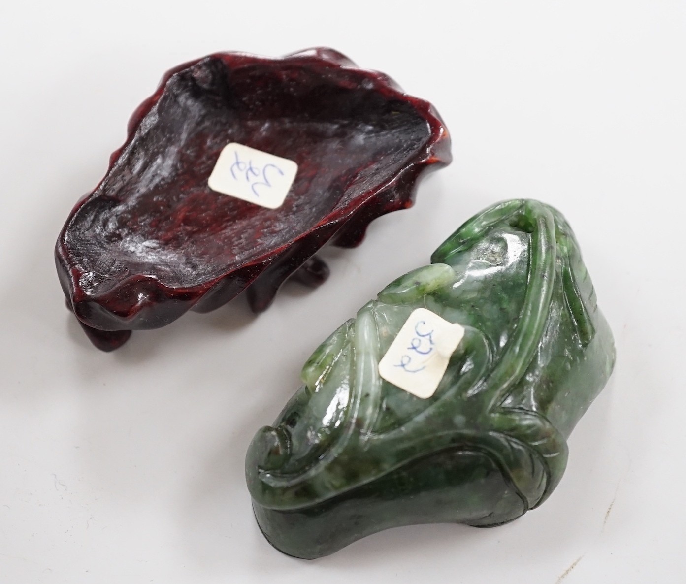 A Chinese spinach green jade 'lotus' brushwasher, 19th century, 6.8cm, wood stand